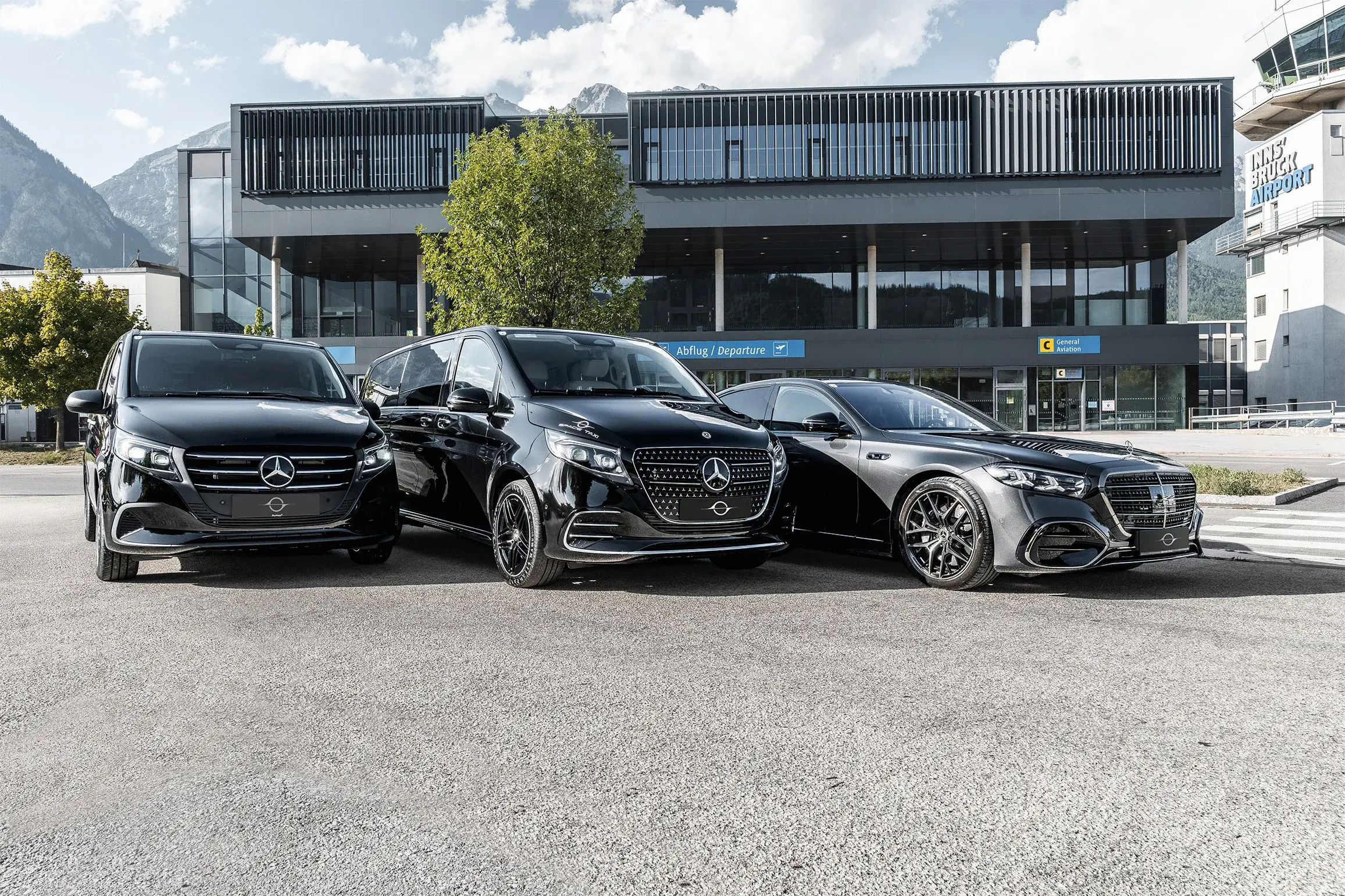 The three black Space Taxi Mercedes in front of the departures terminal at Innsbruck Airport